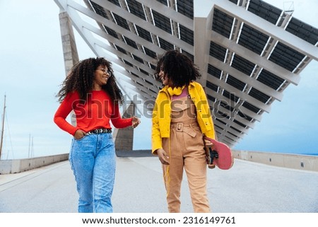young happy women having fun outdoor , laughing and sharing good mood. Teenagers girls walking at the harbor in Barcelona after school