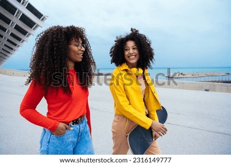 young happy women having fun outdoor , laughing and sharing good mood. Teenagers girls walking at the harbor in Barcelona after school
