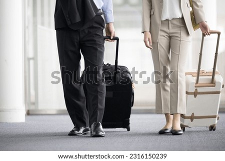 No-face with an image of overseas business trips and airports with Japanese businessmen and women with carry-on bags that are easy to use at train stations, airports, business trips and travel. Royalty-Free Stock Photo #2316150239