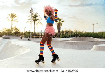 Beautiful woman skating with roller skates and having fun. Professional skater and dancer training in the morning wearing colored and fashionable clothes. Royalty-Free Stock Photo #2316150805