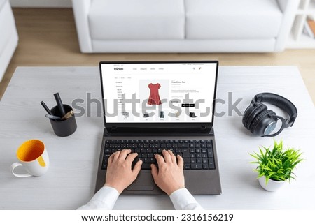 Stylish woman exploring the clothes online, shopping, selecting a beautiful red dress that perfectly complements her taste and personality Royalty-Free Stock Photo #2316156219