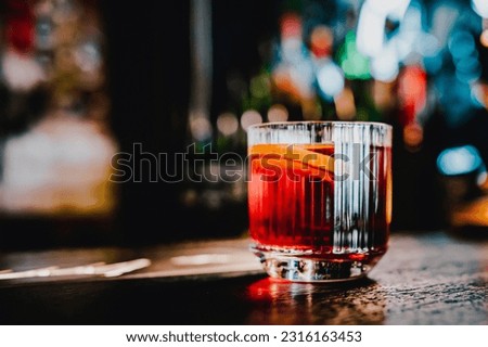 Cocktail Negroni with gin, campari martini rosso and orange. negroni cocktail in bar Royalty-Free Stock Photo #2316163453