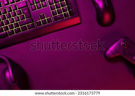 Green lit keyboard with gaming gadgets