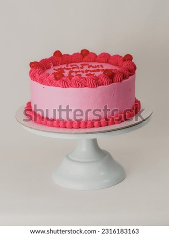 Pink frosted icing elegnt cake with funny lettering topper. Celebration cupcake. Humor in food concept. Be strong be bad. Royalty-Free Stock Photo #2316183163