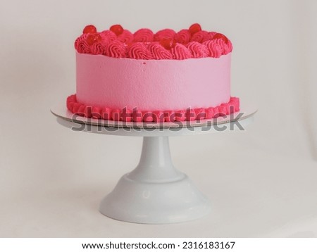 Pink frosted icing elegnt cake with funny lettering topper. Celebration cupcake. Humor in food concept. Be strong be bad. Royalty-Free Stock Photo #2316183167