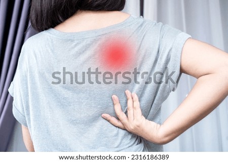 Woman suffering from Scapulocostal Syndrome Back and Shoulder Muscle Pain Royalty-Free Stock Photo #2316186389