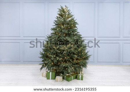 Many different gift boxes under Christmas tree indoors