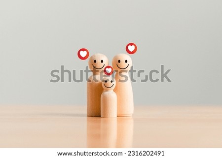 Happy family with one child and heart emotion on wooden background. Wood doll character. Togetherness relationship and lifestyle concept.