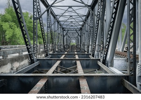 The Iron Black Bridge Bridging World Wars I and II which is a railway bridge over the Wang River is a travel history destination and landmark and an important tourist attraction in Lampang, Thailand.