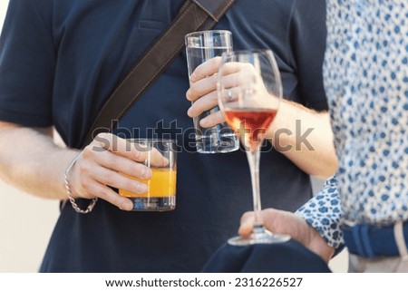Two person drinking alcoholic drinks at the outdoors party