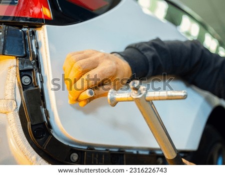 Removal of dents without painting. PDR technology for car body repair. PDR. The mechanic at the auto shop with tools to repair dents in car body. Body repair.
 Royalty-Free Stock Photo #2316226743