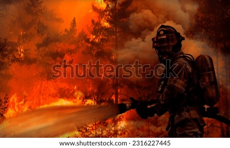 Firemen fighting a raging fire with flames. Forest fire. Royalty-Free Stock Photo #2316227445