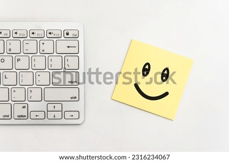 Symbol smile face paper office laptop computer keyboard on table background.
Feedback employee team positive business,
World mental health day, 