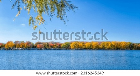 Picture of an artificial lake in a Quebec campground during the fall season colors