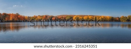 Picture of an artificial lake in a Quebec campground during the fall season colors