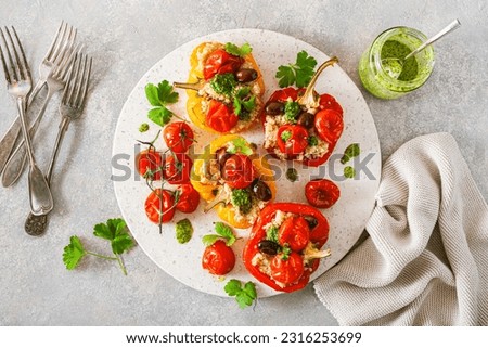 stuffed bell peppers with quinoa tomatoes olives and herb sauce chimichurri Royalty-Free Stock Photo #2316253699
