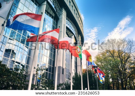 Waiving flags in front of European Parliament building. Brussels, Belgium