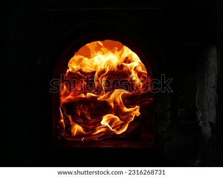A closeup of fiery flames in an incinerator Royalty-Free Stock Photo #2316268731