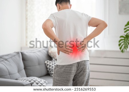 Back pain, kidney inflammation, man suffering from backache at home, health problems concept Royalty-Free Stock Photo #2316269553