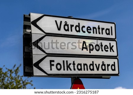 Skelleftea, Sweden A street sign in Swedish pointing towards the district health center, a pharmacy and dentist services.