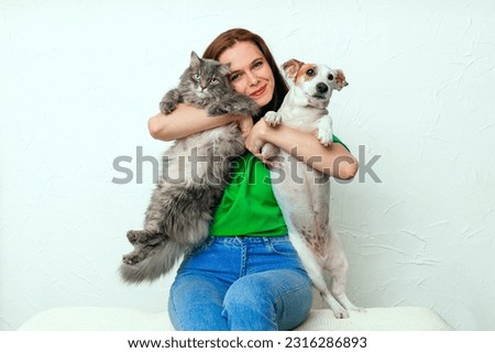 A girl with her cat and dog Royalty-Free Stock Photo #2316286893