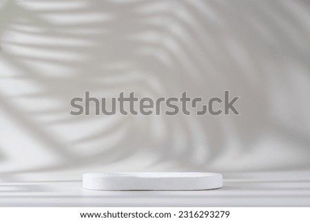 White background of wall with palm shadows and podium. Free space for your decoration. product presentation, mock up, show cosmetic product display, Podium, stage pedestal or platform. Royalty-Free Stock Photo #2316293279