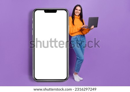 Full length photo of successful glad lady wear stylish clothes demonstrate empty space device shop isolated on purple color background