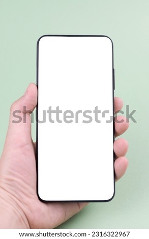 Phone in the hand on a green background