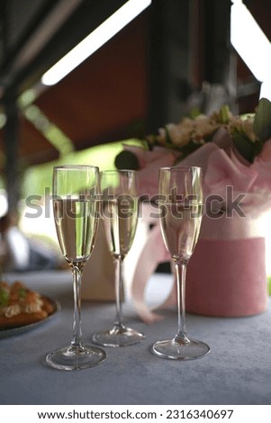 Three glasses of champagne on the buffet table.                    