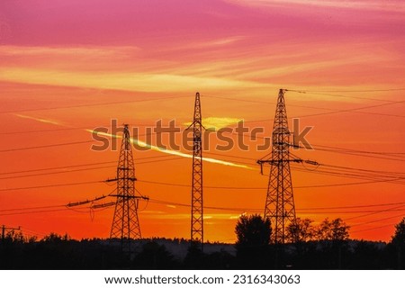 Three metal poles with power lines at sunset, anthropomorphic silhouette, industrial photography, golden hour photo, electric poles and wires, pulsating energy, beautiful sky after sunset