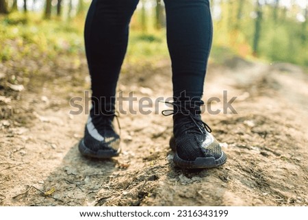 Athlete running on the road trail in sunset training for marathon and fitness. motion blur of woman exercising outdoors in the forest. High quality photo