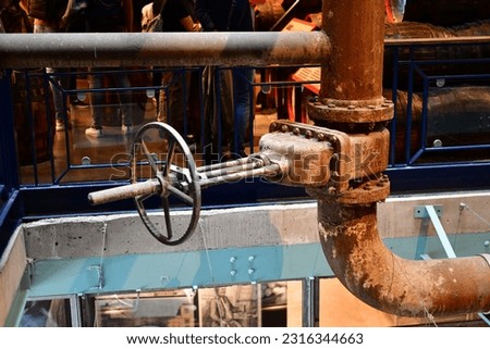 Industrial pipes and beams in old factory Royalty-Free Stock Photo #2316344663