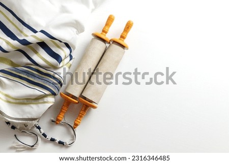 Torah scroll with Tallit on a light background Royalty-Free Stock Photo #2316346485