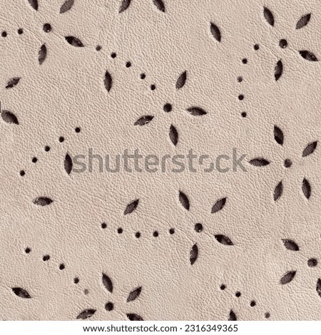 Texture of perforated genuine leather, embossed floral pattern. Modern background, copy space