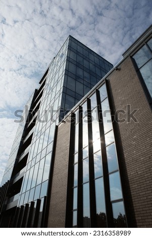 Modern office building with glass facade and blue sky. Business background. modern architecture in the city