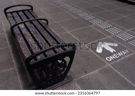Bench and one way sign on the pedestrian street