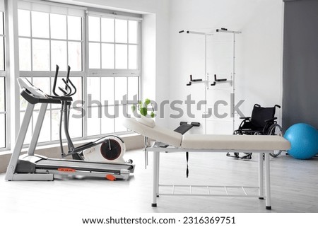 Interior of rehabilitation center with couch and equipment Royalty-Free Stock Photo #2316369751