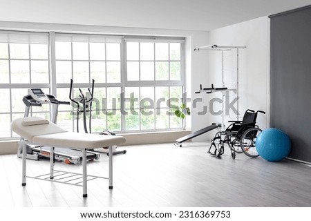 Interior of rehabilitation center with couch and equipment Royalty-Free Stock Photo #2316369753