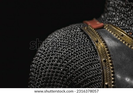 Close-up and texture of a chain of handmade real chain mail armor, authentic armor of a medieval knight on a dark background, selective focus