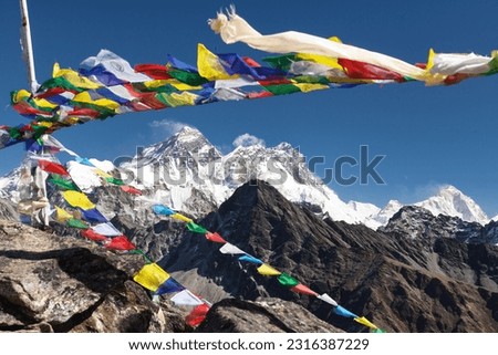 view of Mount Everest, Mt Lhotse and Makalu peak with buddhist prayer flags from Gokyo Ri peak, Khumbu valley,  Nepal Himalayas mountains Royalty-Free Stock Photo #2316387229
