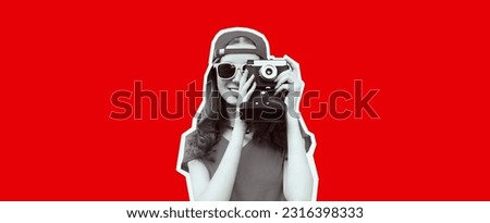 Portrait of happy smiling young woman photographer taking picture on film camera wearing red baseball cap on red background, magazine style