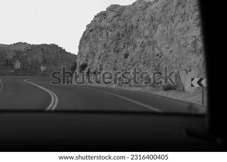 Black and White Road Curve View from Car. Scenic Road in Rocky Desert Terrain. Israel.