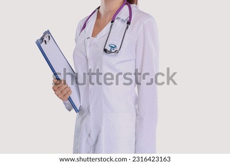 Smiling female doctor in uniform standing at hospital