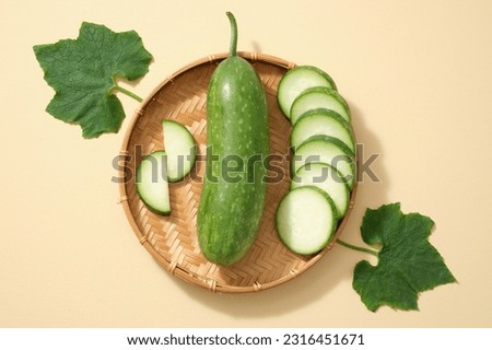 Against the beige background, fresh winter melon, slices and green leaves placed on bamboo basket. Minimal concept with top view, flat lay for advertising product of winter melon ingredient Royalty-Free Stock Photo #2316451671