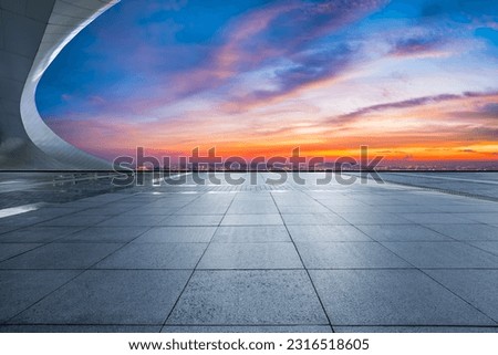 Empty square floor and city skyline with sky clouds at sunset