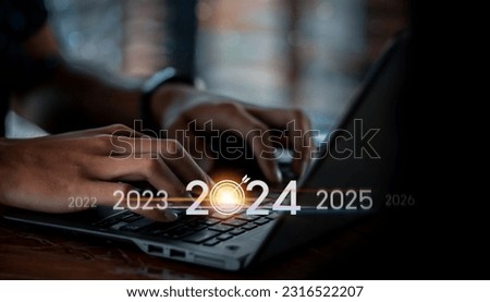 Trend of 2024. people business investor using laptop with virtual 2024 year diagram, business trend, change from 2023 to 2024, strategy, investment, business planning and happy new year concept Royalty-Free Stock Photo #2316522207