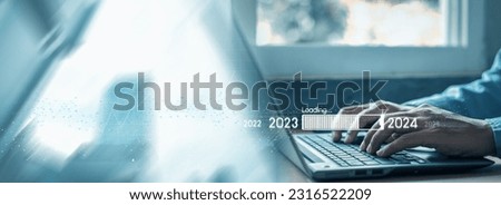 Countdown to 2024 concept. the taps a virtual download bar with a loading progress meter on New Year's Eve, turning the year 2023 to 2024. Royalty-Free Stock Photo #2316522209