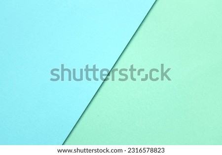 two tone green pastel and blue pastel paper color for background. two color paper with overlay on the floor And split half of the image. background.top view with place for text
