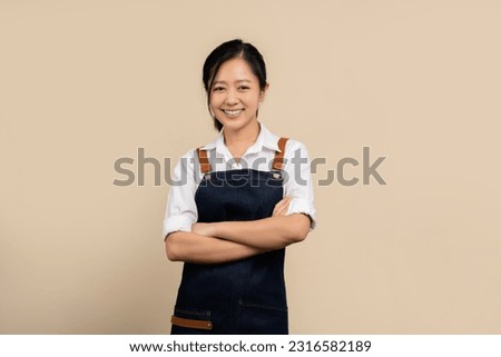 Start a small business. Happy young asian businesswoman wearing white shirt and apron.