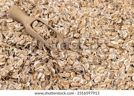 a bunch of fresh dry oatmeal flakes for making porridge, a large number of large oatmeal flakes for making breakfast Royalty-Free Stock Photo #2316597913
